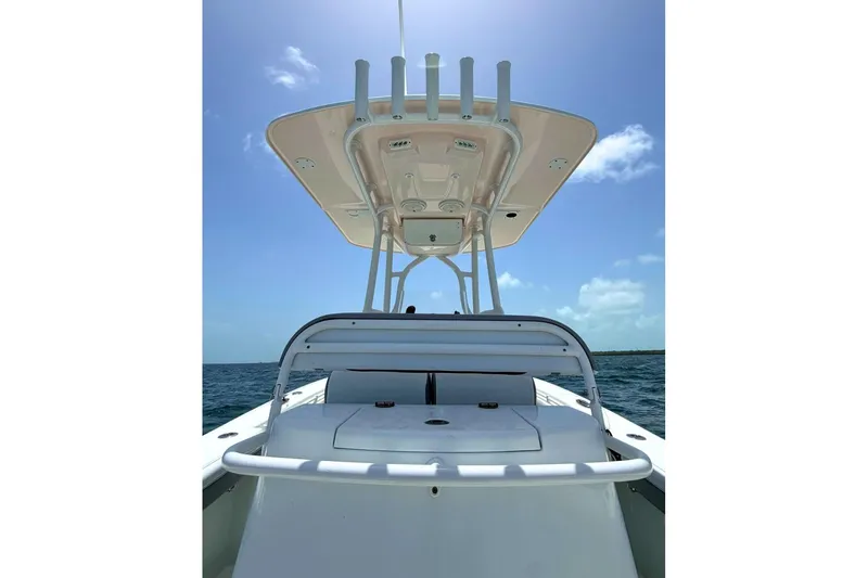 Slide: The Image of 2018 Yellowfin 26 Hybrid boat on open water under clear blue sky. - 12