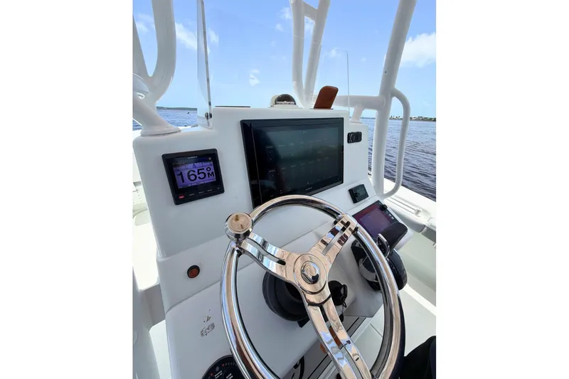 Slide: The Image of Steering console of 2018 Yellowfin 26 Hybrid boat with navigation displays. - 19