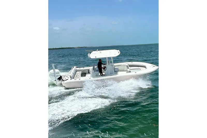 Slide: The Image of 2018 Yellowfin 26 Hybrid boat cruising on open water under clear skies. - 5