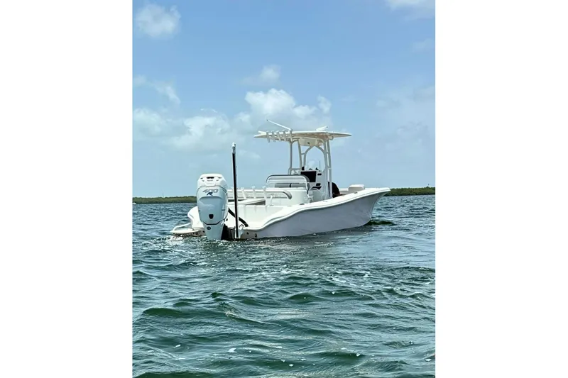 Slide: The Image of 2018 Yellowfin 26 Hybrid boat on open water under clear sky. - 8