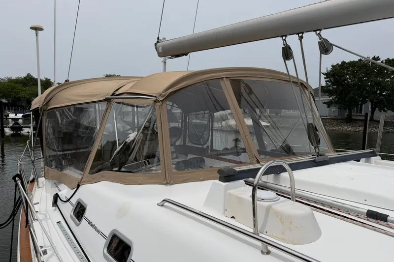 Slide: The Image of 2007 Beneteau 423 sailboat with beige canopy docked at marina. - 9