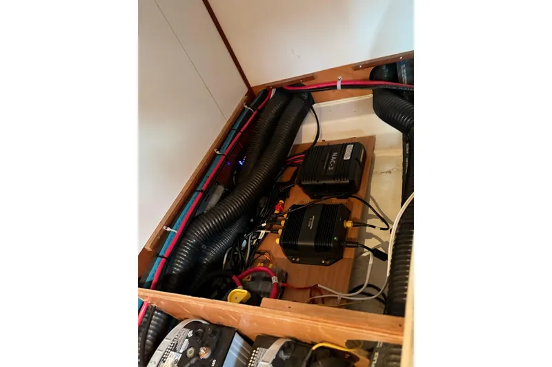 Slide: The Image of Electrical system inside a 2007 Beneteau 423 yacht, featuring wiring and components. - 53