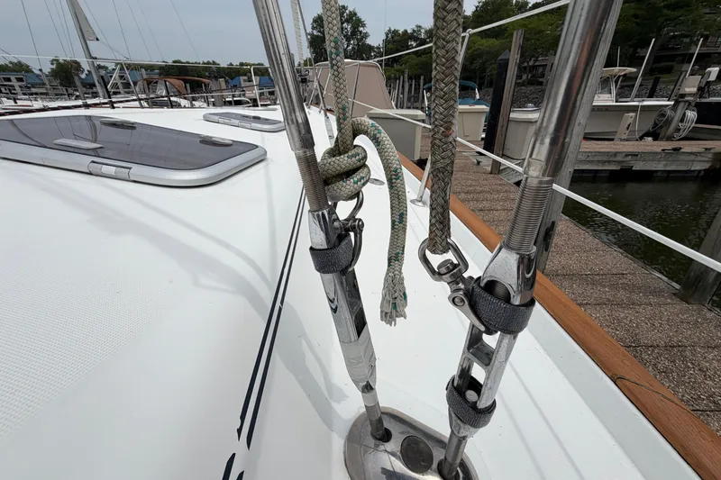 Slide: The Image of Deck view of a 2007 Beneteau 423 sailboat, featuring rigging and dock background. - 21
