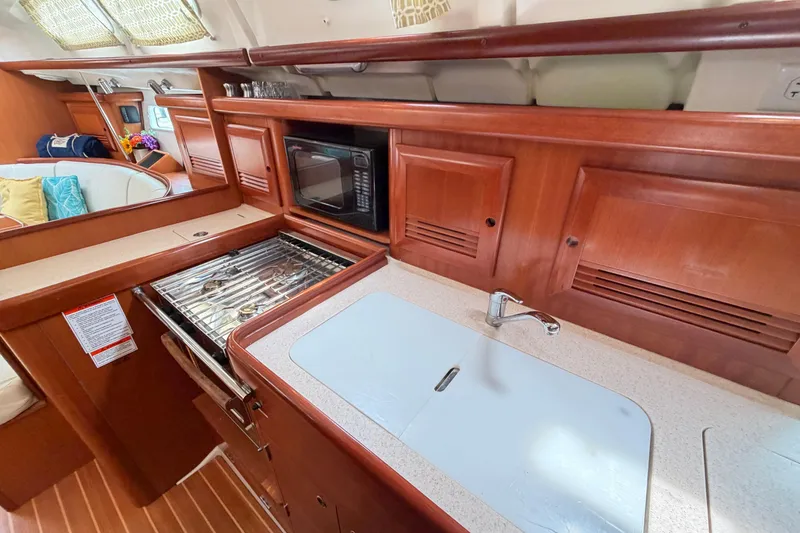 Slide: The Image of Interior of 2007 Beneteau 423 yacht kitchen with stove, sink, and microwave. - 29