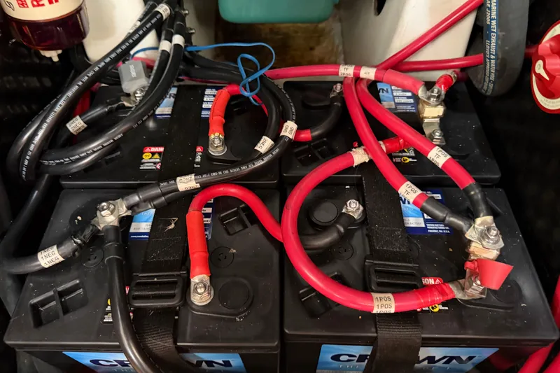 Slide: The Image of Battery setup in a 2007 Beneteau 423 sailboat, featuring red and black cables. - 50
