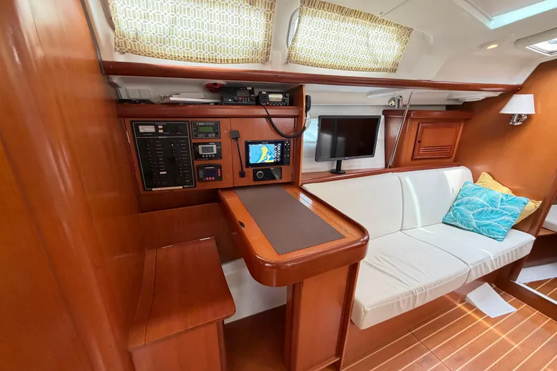 Slide: The Image of Interior of 2007 Beneteau 423 yacht with navigation station and cozy seating area. - 30