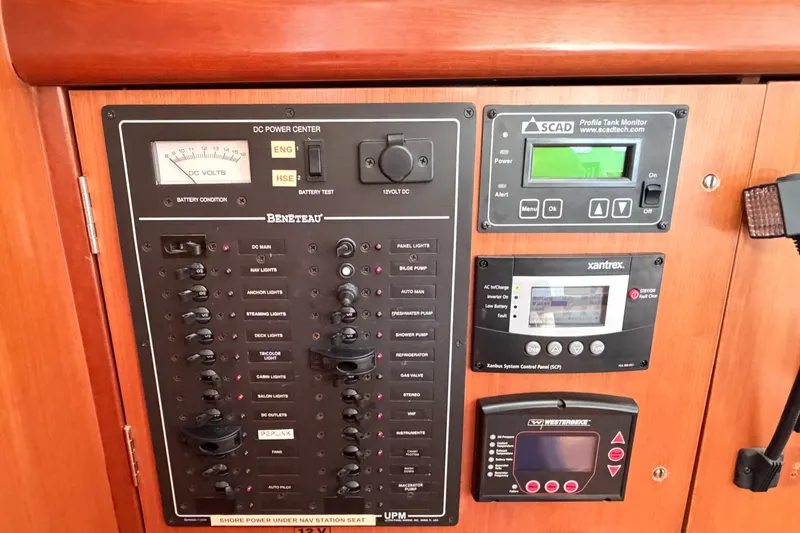 Slide: The Image of Electrical control panel on a 2007 Beneteau 423 sailboat, featuring various switches and monitors. - 32