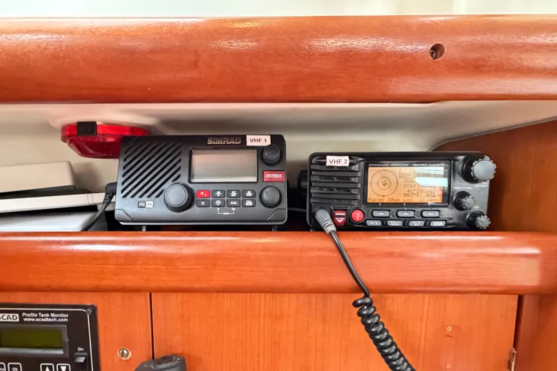 Slide: The Image of VHF radios on a 2007 Beneteau 423 yacht, featuring Simrad and Standard Horizon models. - 34
