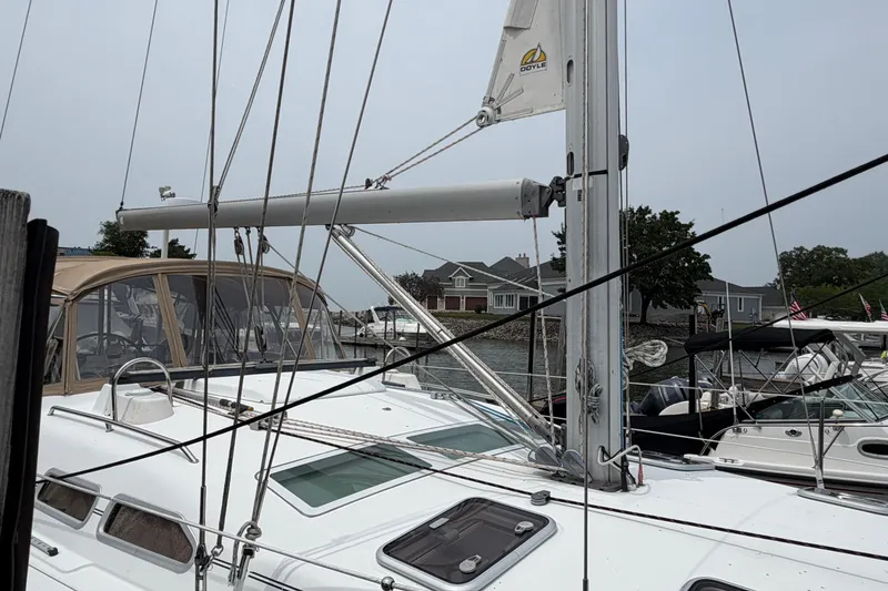 Slide: The Image of 2007 Beneteau 423 sailboat docked, showcasing mast and deck details. - 5