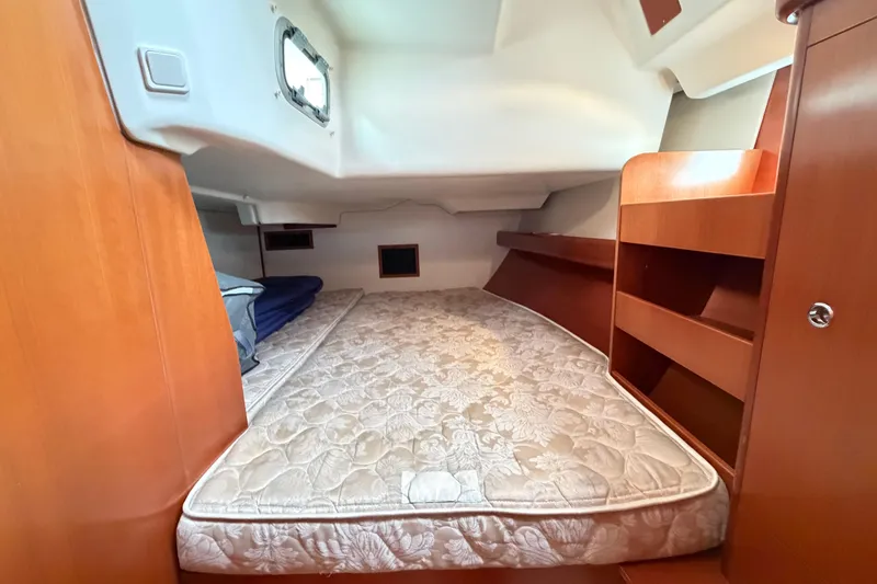 Slide: The Image of Interior cabin of 2007 Beneteau 423 yacht with cozy bed and wooden shelving. - 40