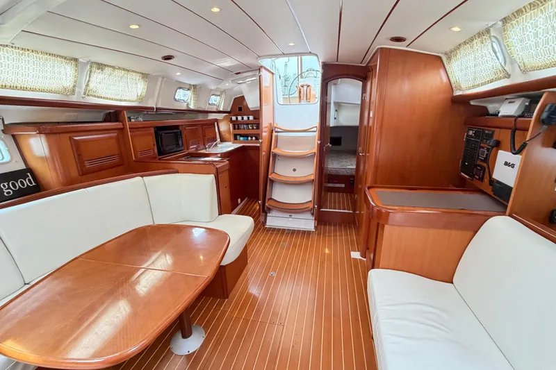 Slide: The Image of Luxurious interior of a 2007 Beneteau 423 yacht with wood finishes and comfortable seating. - 38