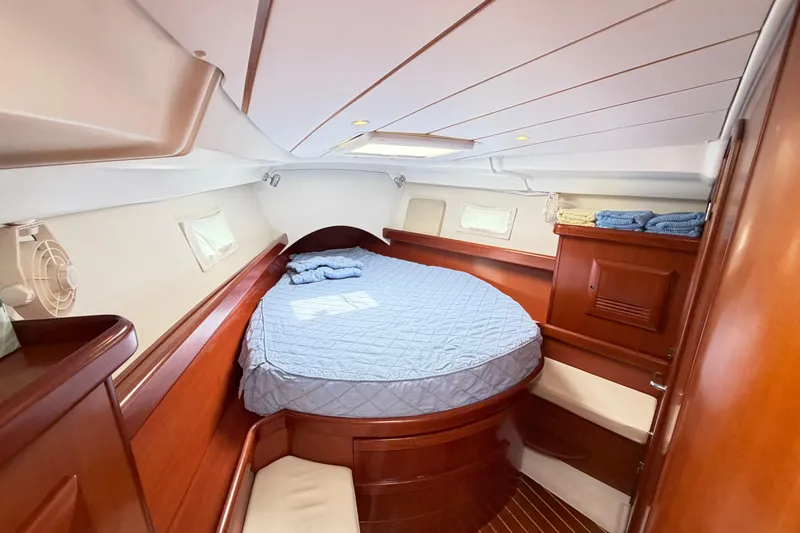 Slide: The Image of Luxurious cabin interior of 2007 Beneteau 423 yacht with cozy bed and wooden finish. - 42