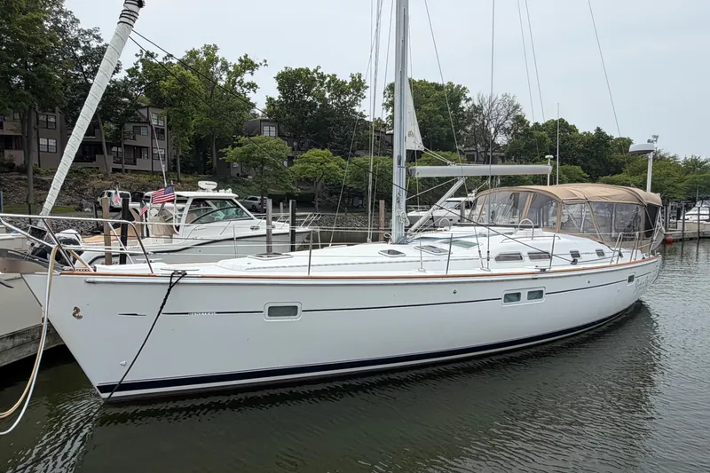 The Image of 2007 Beneteau 423 sailboat docked in a marina, surrounded by trees and other boats. - 0