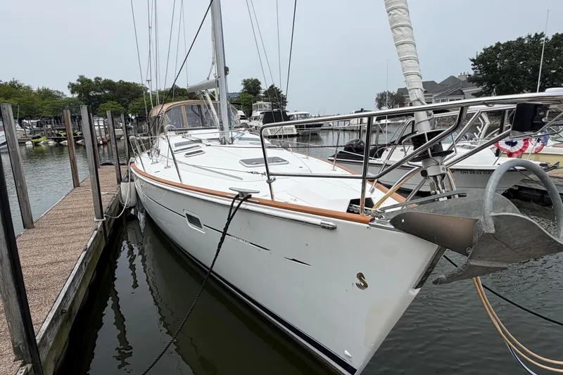 Slide: The Image of 2007 Beneteau 423 sailboat docked at a marina, showcasing sleek design and modern features. - 2