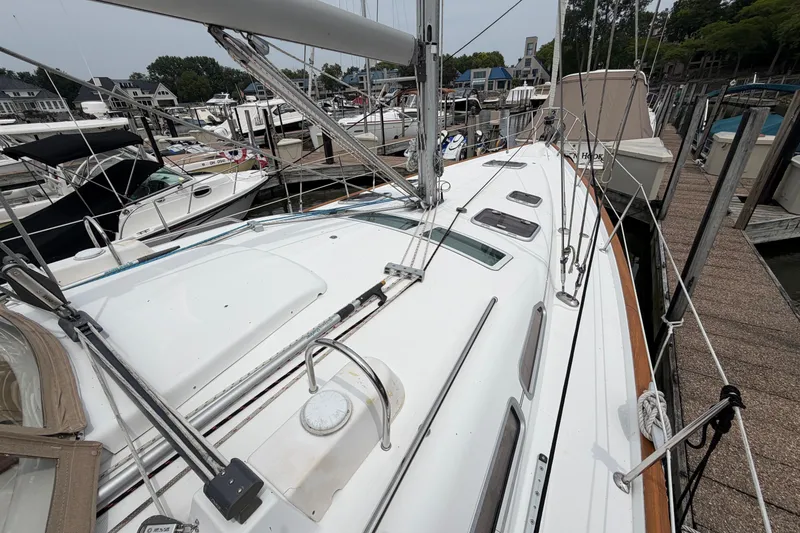 Slide: The Image of 2007 Beneteau 423 sailboat docked at marina, showcasing sleek deck design and rigging. - 20