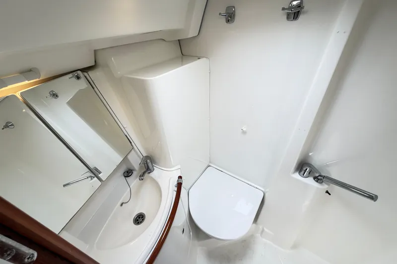 Slide: The Image of Bathroom interior of 2007 Beneteau 423 yacht, featuring sink, mirror, and toilet. - 45