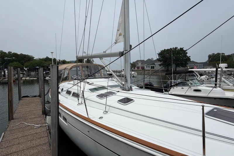 Slide: The Image of 2007 Beneteau 423 sailboat docked at a marina, showcasing sleek design and spacious deck. - 3