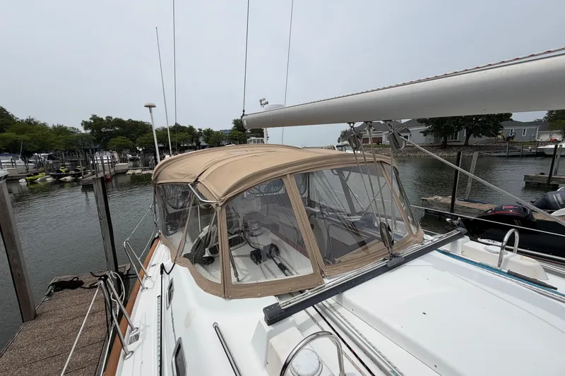 Slide: The Image of 2007 Beneteau 423 sailboat docked at marina with beige canopy. - 7