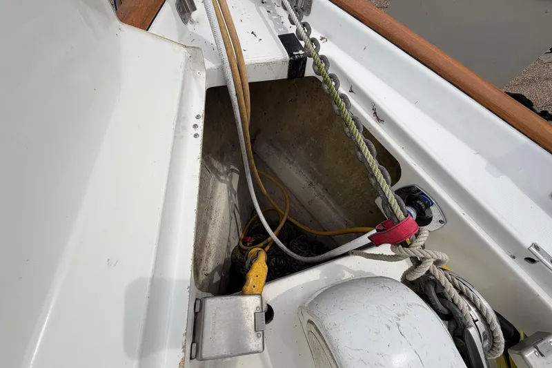 Slide: The Image of Open compartment on a 2007 Beneteau 423 sailboat, showing ropes and electrical connections. - 23