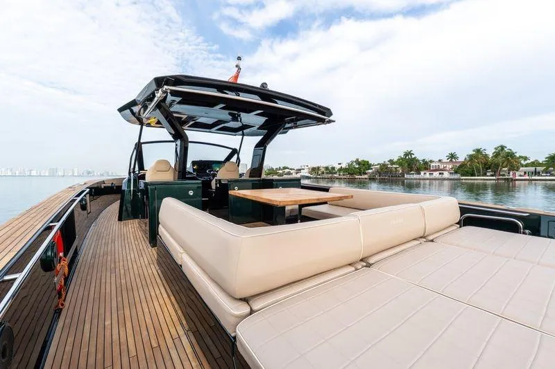 Slide: The Image of 2020 Pardo Yachts 50 with spacious deck and luxurious seating, docked by serene waters. - 45