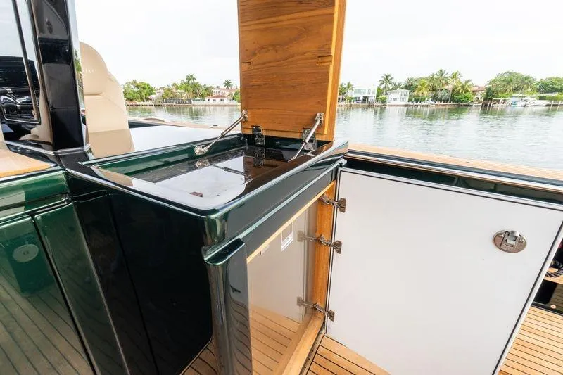 Slide: The Image of Outdoor kitchenette on 2020 Pardo Yachts 50, featuring a sink and storage, with scenic waterfront view. - 43