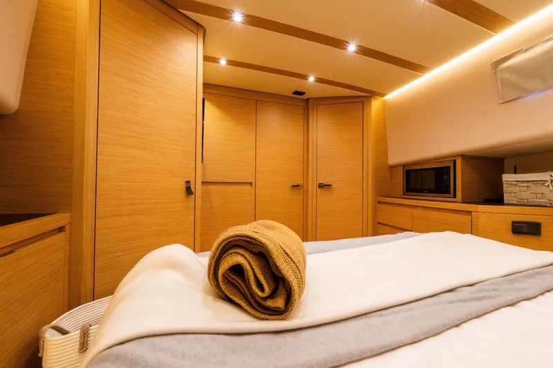 Slide: The Image of Luxurious interior of 2020 Pardo Yachts 50, featuring elegant wood finishes and cozy bedding. - 71
