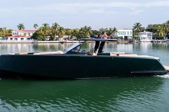 Slide: The Image of 2020 Pardo Yachts 50 cruising on a serene waterfront with palm trees and luxury homes. - 30
