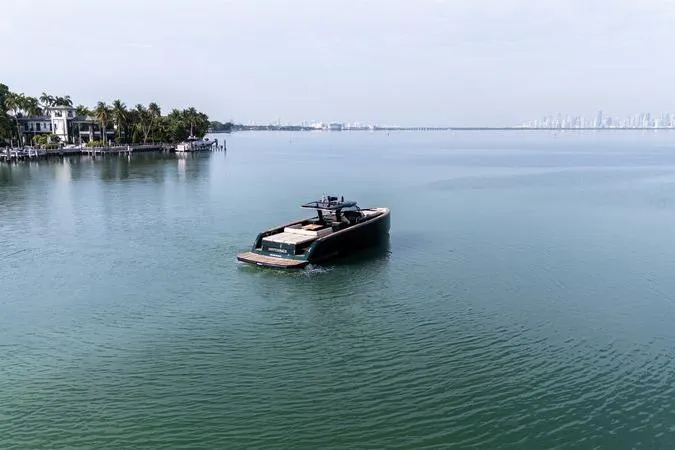 Slide: The Image of Luxury 2020 Pardo Yachts 50 cruising on calm waters near a coastal cityscape. - 21