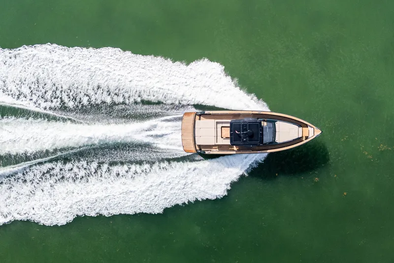 Slide: The Image of Aerial view of 2020 Pardo Yachts 50 cruising on green water, leaving a wake. - 20