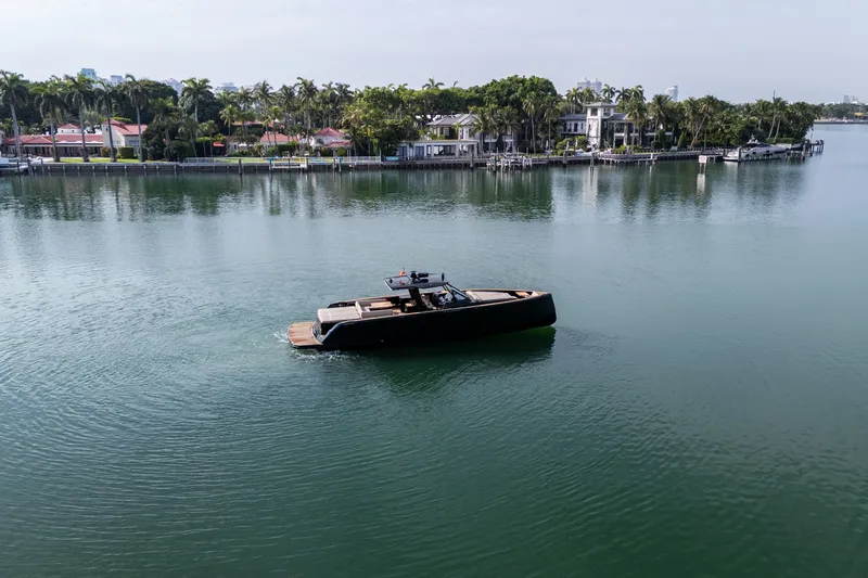 Slide: The Image of 2020 Pardo Yachts 50 cruising on calm waters near luxury waterfront homes. - 19