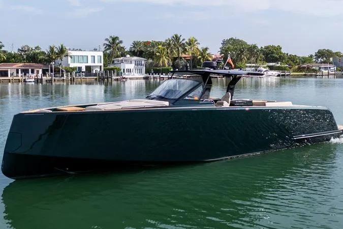 Slide: The Image of Luxury 2020 Pardo Yachts 50 cruising on a serene waterfront with palm trees. - 40