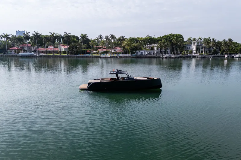 Slide: The Image of 2020 Pardo Yachts 50 on calm water near luxury waterfront homes. - 44