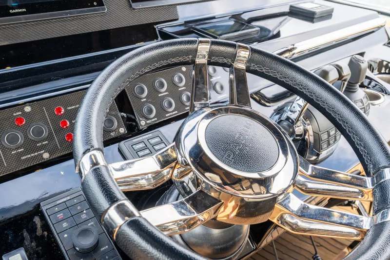 Slide: The Image of Steering wheel and controls of a 2020 Pardo Yachts 50, featuring sleek design elements. - 50