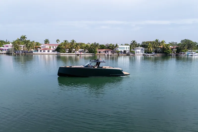 Slide: The Image of Luxury 2020 Pardo Yachts 50 cruising on calm waters near waterfront homes. - 39