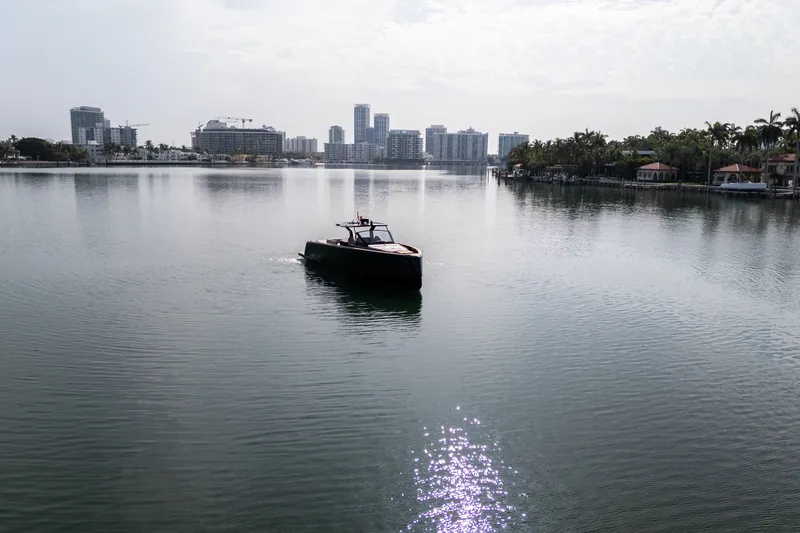 Slide: The Image of Pardo Yachts 50 cruising on a calm waterway with city skyline backdrop. - 42