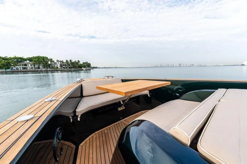 Slide: The Image of Luxurious 2020 Pardo Yachts 50 with elegant deck seating and scenic waterfront view. - 60
