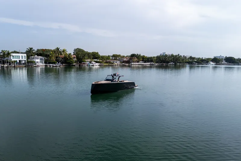 Slide: The Image of Pardo Yachts 50 cruising on a serene lake, surrounded by lush greenery, 2020 model. - 41