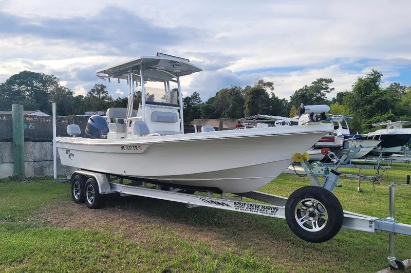 Slide: The Image of 2021 KenCraft Bayrider boat on trailer, parked on grass, with trees and sky in background. - 20