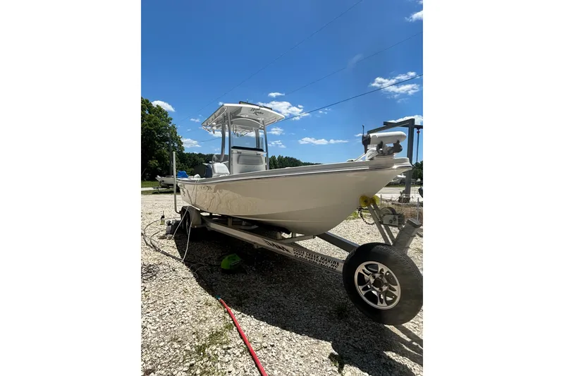 Slide: The Image of 2021 KenCraft Bayrider boat on trailer under clear blue sky. - 4