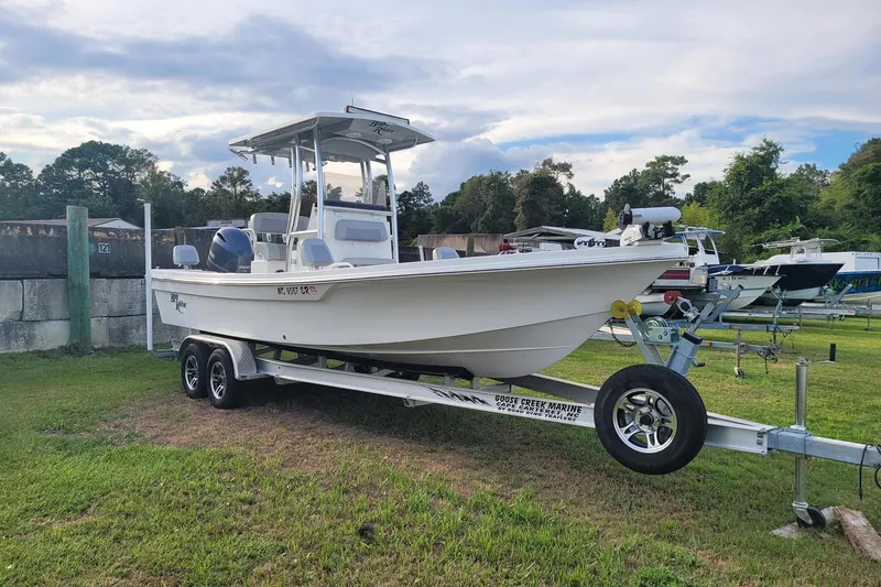 Slide: The Image of 2021 KenCraft Bayrider boat on trailer, parked on grass, with trees and sky in background. - 5