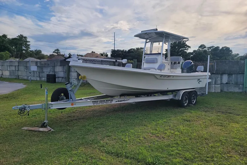 Slide: The Image of 2021 KenCraft Bayrider boat on trailer, parked on grass under cloudy sky. - 17