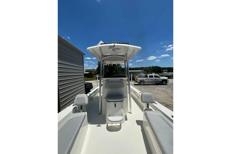 Slide: The Image of 2021 KenCraft Bayrider boat with T-top, parked outdoors under clear blue sky. - 10