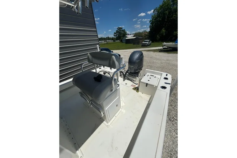 Slide: The Image of 2021 KenCraft Bayrider boat with seating and outboard motor, parked outdoors under clear skies. - 12