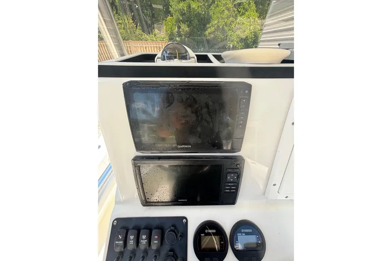 Slide: The Image of 2021 KenCraft Bayrider dashboard with Garmin displays and Yamaha gauges. - 13