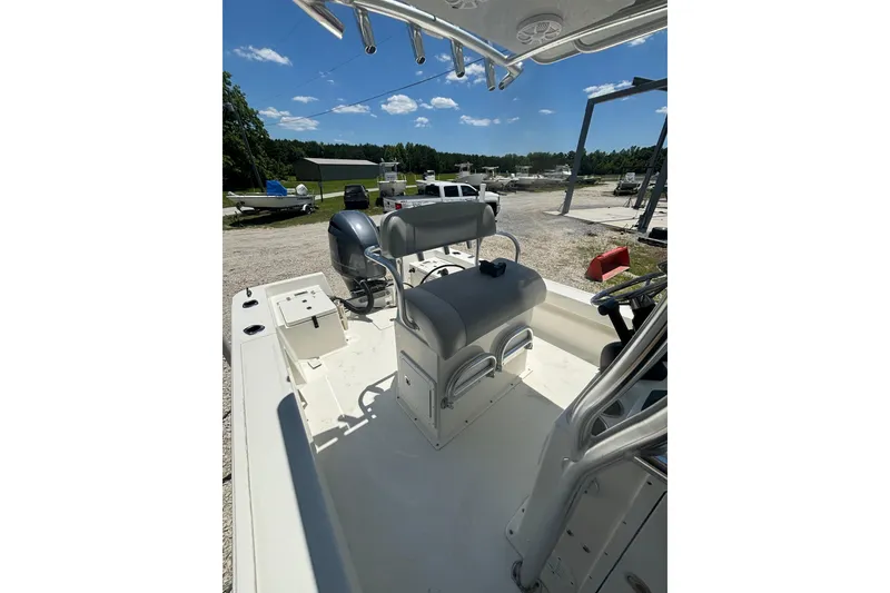 Slide: The Image of 2021 KenCraft Bayrider boat interior with seating and console, parked outdoors under blue sky. - 9