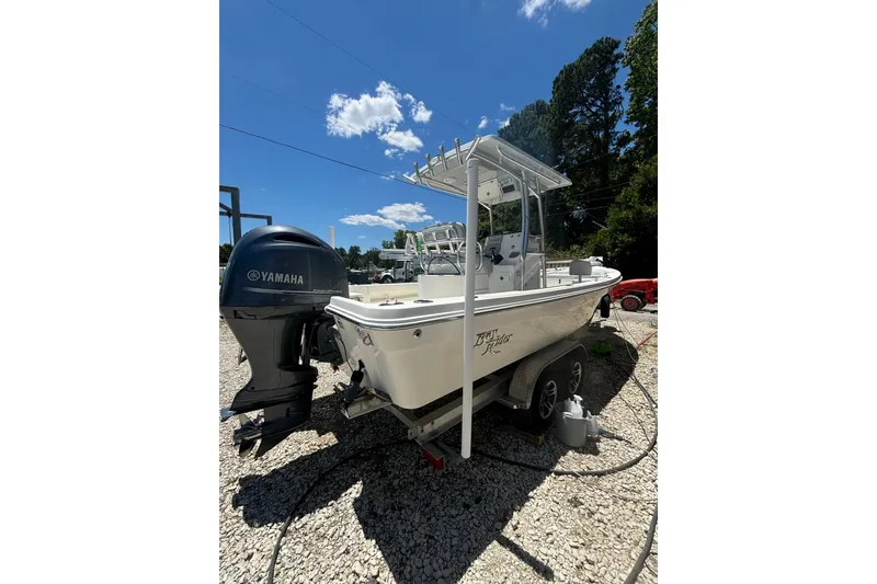 Slide: The Image of 2021 KenCraft Bayrider boat with Yamaha engine on a trailer, under clear blue sky. - 15
