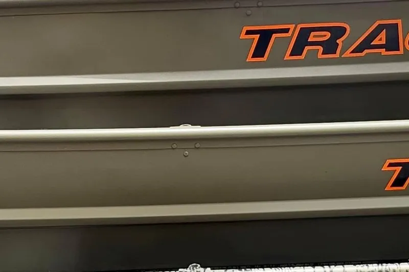 The Image of 2026 Tracker Grizzly 14 Jon boat with bold orange lettering on a sleek gray exterior. - 0