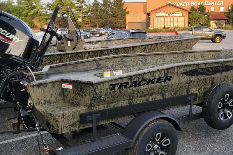 The Image of 2026 Tracker Grizzly 1650 T Prairie Wings Edition boat on trailer at dealership. - 0