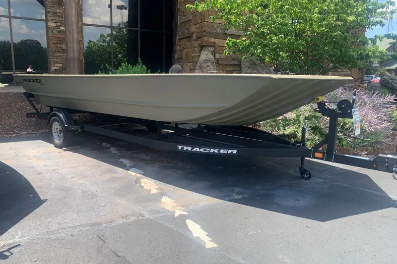 The Image of 2026 Tracker Grizzly 2072 Utility boat on trailer, parked outdoors. - 0