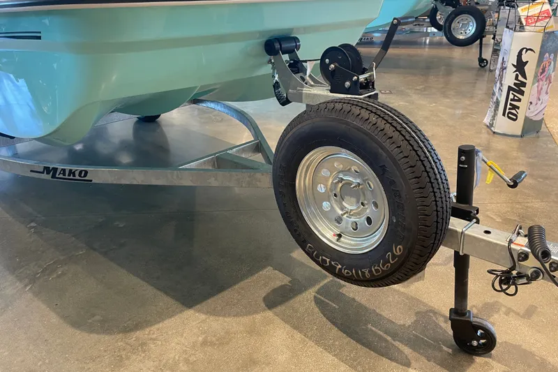 Slide: The Image of 2026 Mako Pro Skiff 15 CC boat on trailer, showroom display. - 5